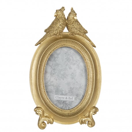 Złota ramka na zdjęcie owalna udekorowana rzeźbionymi papugami.